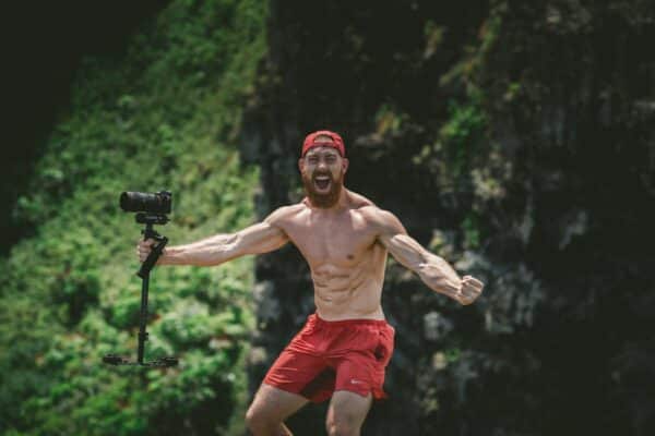 man outdoors camera six pack positive emotions high energy