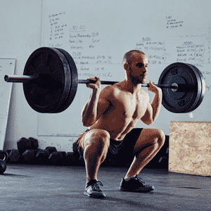 man deep squat heavy weight compound lift