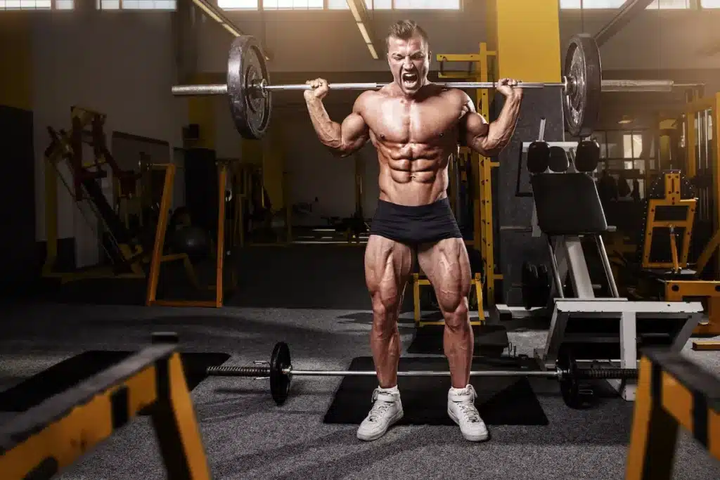 man squat bodybuilder barbell gym legs six pack chest