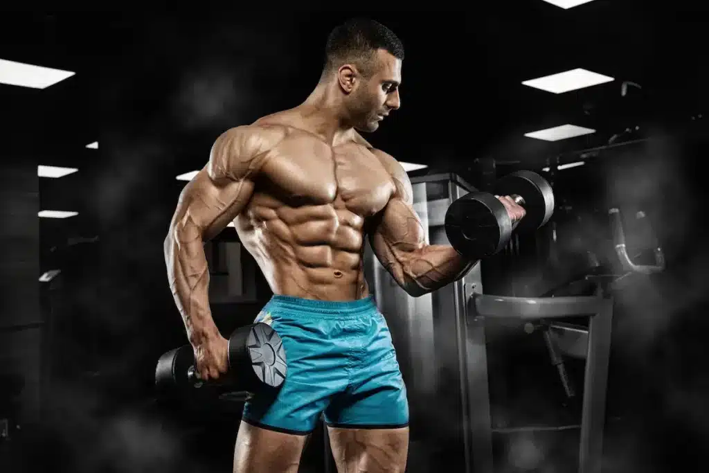 bodybuilder dumbbell curl pose chest arms six pack gym