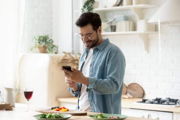 man kitchen cooking wine smart phone social