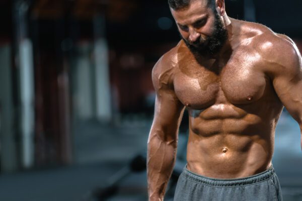 muscular man bodybuilder chest abs shoulders gym