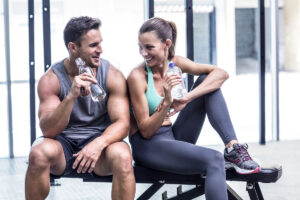Relationships Affect Your Health and Fitness Goals. Image shows a couple drinking water.