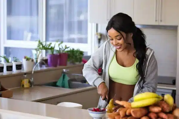 woman kitchen fruit healthy diet how to cut down on snacking between meals
