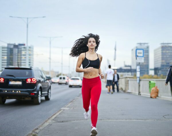 woman outdoors jogging cardio. Cardio improves leg day sexual performance