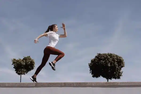woman running skipping outdoors exercise