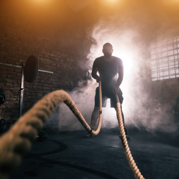 Man Performing battle rope exercise