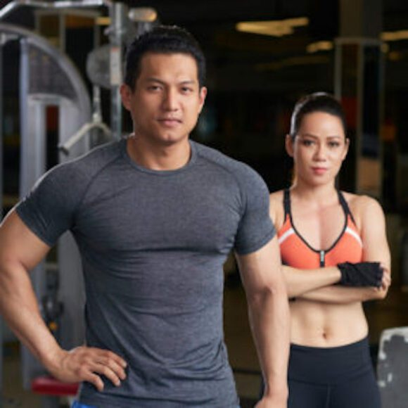 man and woman in gym working out together relationships affect fitness goals