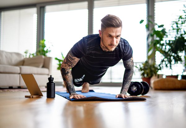 Front,View,Portrait,Of,Man,With,Tablet,Doing,Workout,Exercise Push ups, planks, homework