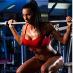 woman-bodybuilder-performing-squat Squats improve power sexual performance burns stomach fat compound lift
