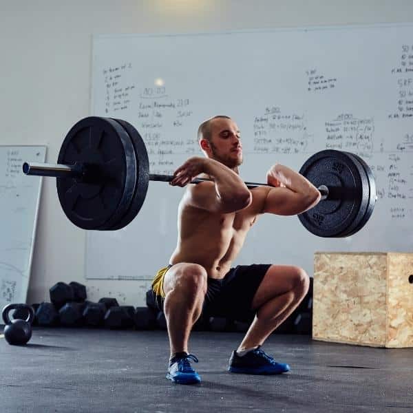 Man Performing Front Squat. bodybuilding training principles